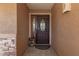 Welcoming front door area with charming stone accents and a decorative gnome figurine at 10718 W Saratoga Cir, Sun City, AZ 85351