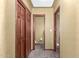 Hallway featuring a set of closet doors, a bathroom, and a room at 10718 W Saratoga Cir, Sun City, AZ 85351