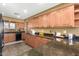 The kitchen features granite countertops and a breakfast bar, complemented by lots of cabinets and lots of counter space at 10718 W Saratoga Cir, Sun City, AZ 85351