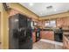 A full suite of black appliances, granite countertops, and ample storage makes this kitchen a home chef's dream at 10718 W Saratoga Cir, Sun City, AZ 85351