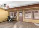 Well-lit office with beamed ceiling, neutral walls, shuttered windows and outside access at 10718 W Saratoga Cir, Sun City, AZ 85351