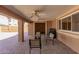 This is a large, covered patio with brick pavers and ceiling fans and includes an outdoor seating area at 10718 W Saratoga Cir, Sun City, AZ 85351