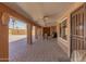 This is a large, covered patio with brick pavers and ceiling fans and includes an outdoor seating area at 10718 W Saratoga Cir, Sun City, AZ 85351