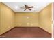 Empty room with hardwood floors, overhead fan, and many electric outlets at 10718 W Saratoga Cir, Sun City, AZ 85351