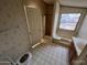 Bathroom with patterned wallpaper, combination shower/tub and window and tile flooring at 10997 N Hualapai Dr, Casa Grande, AZ 85122