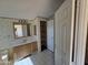 Functional bathroom with a single sink vanity, mirrored medicine cabinet, and linen closet at 10997 N Hualapai Dr, Casa Grande, AZ 85122