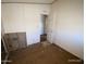 Bedroom needing repair with damaged walls and floors, offering potential for renovation and customization at 10997 N Hualapai Dr, Casa Grande, AZ 85122