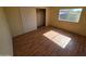 Well-lit bedroom featuring neutral walls, hardwood floors, closet, and window at 10997 N Hualapai Dr, Casa Grande, AZ 85122