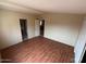Spacious bedroom boasting wood-look flooring, neutral walls, and two access doors at 10997 N Hualapai Dr, Casa Grande, AZ 85122