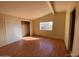 Bright bedroom with natural light, laminate floors, closet, and neutral walls, creating a serene space at 10997 N Hualapai Dr, Casa Grande, AZ 85122