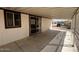 Spacious covered porch with concrete flooring, providing a shaded outdoor space and access to the home at 10997 N Hualapai Dr, Casa Grande, AZ 85122