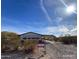 Wide angle shot of a single story home featuring desert landscaping and a covered parking area at 10997 N Hualapai Dr, Casa Grande, AZ 85122