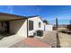 Exterior showcasing an AC unit, storage shed, desert landscape, and covered patio at 10997 N Hualapai Dr, Casa Grande, AZ 85122