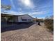 A bright single-story home with desert landscape and a covered awning at 10997 N Hualapai Dr, Casa Grande, AZ 85122