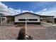 Charming single-story home featuring desert landscaping and a covered carport for convenient parking at 10997 N Hualapai Dr, Casa Grande, AZ 85122