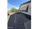 Single-story home featuring low-maintenance gravel landscaping, desert plants, and a covered window at 10997 N Hualapai Dr, Casa Grande, AZ 85122