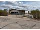 Charming single-story home featuring desert landscaping, fenced yard, and white siding under a cloudy sky at 10997 N Hualapai Dr, Casa Grande, AZ 85122