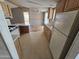 Functional kitchen featuring wood cabinets, a dual basin sink, and an adjacent dining area with ceiling fan at 10997 N Hualapai Dr, Casa Grande, AZ 85122