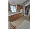 Kitchen featuring wood cabinets, laminate countertops, dual basin sink, and white appliances at 10997 N Hualapai Dr, Casa Grande, AZ 85122