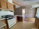 Cozy kitchen with light cabinets, white appliances and an opening to another room, providing a classic design at 10997 N Hualapai Dr, Casa Grande, AZ 85122