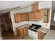 View of a kitchen featuring white countertops, wooden cabinets, and a white gas stove at 10997 N Hualapai Dr, Casa Grande, AZ 85122