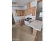 Functional kitchen featuring wood cabinets, laminate countertops, and white appliances at 10997 N Hualapai Dr, Casa Grande, AZ 85122