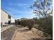 A well-maintained yard offers desert landscaping, featuring mature trees and shrubs at 10997 N Hualapai Dr, Casa Grande, AZ 85122