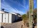 A well-maintained shed and mature desert plants adorn this home's backyard at 10997 N Hualapai Dr, Casa Grande, AZ 85122