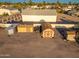 Aerial view of property with outbuildings, large lot, and fenced perimeter at 11138 W Hatcher Rd, Sun City, AZ 85351