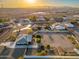 Aerial view of home with spacious lot, outbuildings, and distant mountain views at 11138 W Hatcher Rd, Sun City, AZ 85351