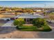 An aerial view of property featuring lush landscaping, a spacious patio, mature trees, and a circular driveway at 11138 W Hatcher Rd, Sun City, AZ 85351