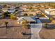 Aerial view of a desert home with mature landscaping and a long driveway in a quiet community at 11138 W Hatcher Rd, Sun City, AZ 85351