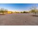 Huge backyard featuring space, mature landscaping, storage buildings, and potential for your outdoor living dreams at 11138 W Hatcher Rd, Sun City, AZ 85351