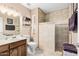 Bathroom with a shower featuring a tiled wall and neutral color scheme at 11138 W Hatcher Rd, Sun City, AZ 85351