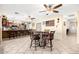 Open concept kitchen and dining area with neutral walls and ceramic tile at 11138 W Hatcher Rd, Sun City, AZ 85351