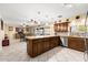 Open concept kitchen with eat-in bar, stainless appliances and lots of cabinet space at 11138 W Hatcher Rd, Sun City, AZ 85351