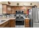 Well-appointed kitchen features stainless steel appliances and ample wooden cabinetry at 11138 W Hatcher Rd, Sun City, AZ 85351