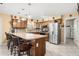 Spacious kitchen features eat-in bar, stainless refrigerator, and lots of cabinet space at 11138 W Hatcher Rd, Sun City, AZ 85351