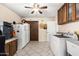 Functional laundry room with washer, dryer, storage, and a ceiling fan for added comfort and convenience at 11138 W Hatcher Rd, Sun City, AZ 85351