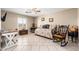 Versatile living area with a window, ceiling fan, and space for relaxing and entertaining at 11138 W Hatcher Rd, Sun City, AZ 85351