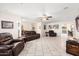 Wide open living area with neutral walls and decorative ceiling fan at 11138 W Hatcher Rd, Sun City, AZ 85351