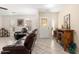 Bright living room features ceramic tile flooring and comfortable leather seating at 11138 W Hatcher Rd, Sun City, AZ 85351