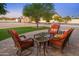 Picturesque outdoor patio featuring comfortable seating, a lush lawn, and mature trees, creating a tranquil retreat at 11138 W Hatcher Rd, Sun City, AZ 85351