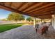 Expansive outdoor patio showcasing stylish seating, lush green spaces, and mature trees creating a serene atmosphere at 11138 W Hatcher Rd, Sun City, AZ 85351