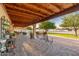 Spacious outdoor patio featuring comfortable seating, potted plants, and a serene view of the landscaped backyard at 11138 W Hatcher Rd, Sun City, AZ 85351