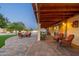 Stunning outdoor patio area with ample seating, showcasing a beautiful lawn and the home's charming exterior at dusk at 11138 W Hatcher Rd, Sun City, AZ 85351