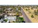 Street view showing lush landscaping, palm trees, and a distant stadium at 1129 W Holly St, Phoenix, AZ 85007