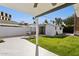 Comfortable backyard featuring a patio, dining set, and well-manicured lawn at 1129 W Holly St, Phoenix, AZ 85007