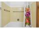 Well-maintained bathroom features a tub with a floral shower curtain and convenient grab bars for accessibility at 1129 W Holly St, Phoenix, AZ 85007