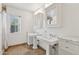 Bright bathroom featuring two pedestal sinks with a window that brings in plenty of natural light at 1129 W Holly St, Phoenix, AZ 85007